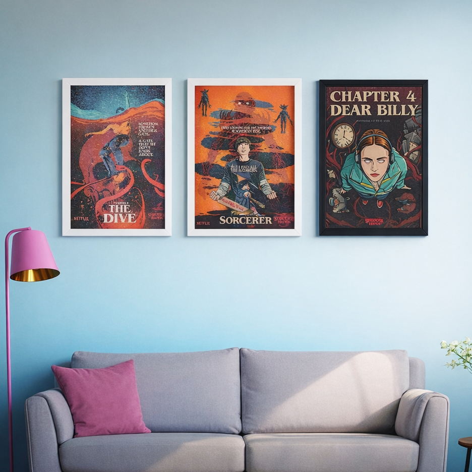Three posters on a wall above a gray sofa with a pink lamp and plant.